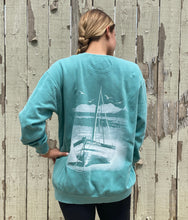 Faded teal comfort color sweatshirt with beach bound design on the back. Design is a white sailboat on white sand with an ocean background.