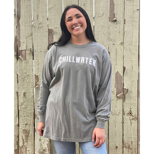 Woman wearing grey long sleeve chillwater t-shirt with chillwater airborne logo on the front.