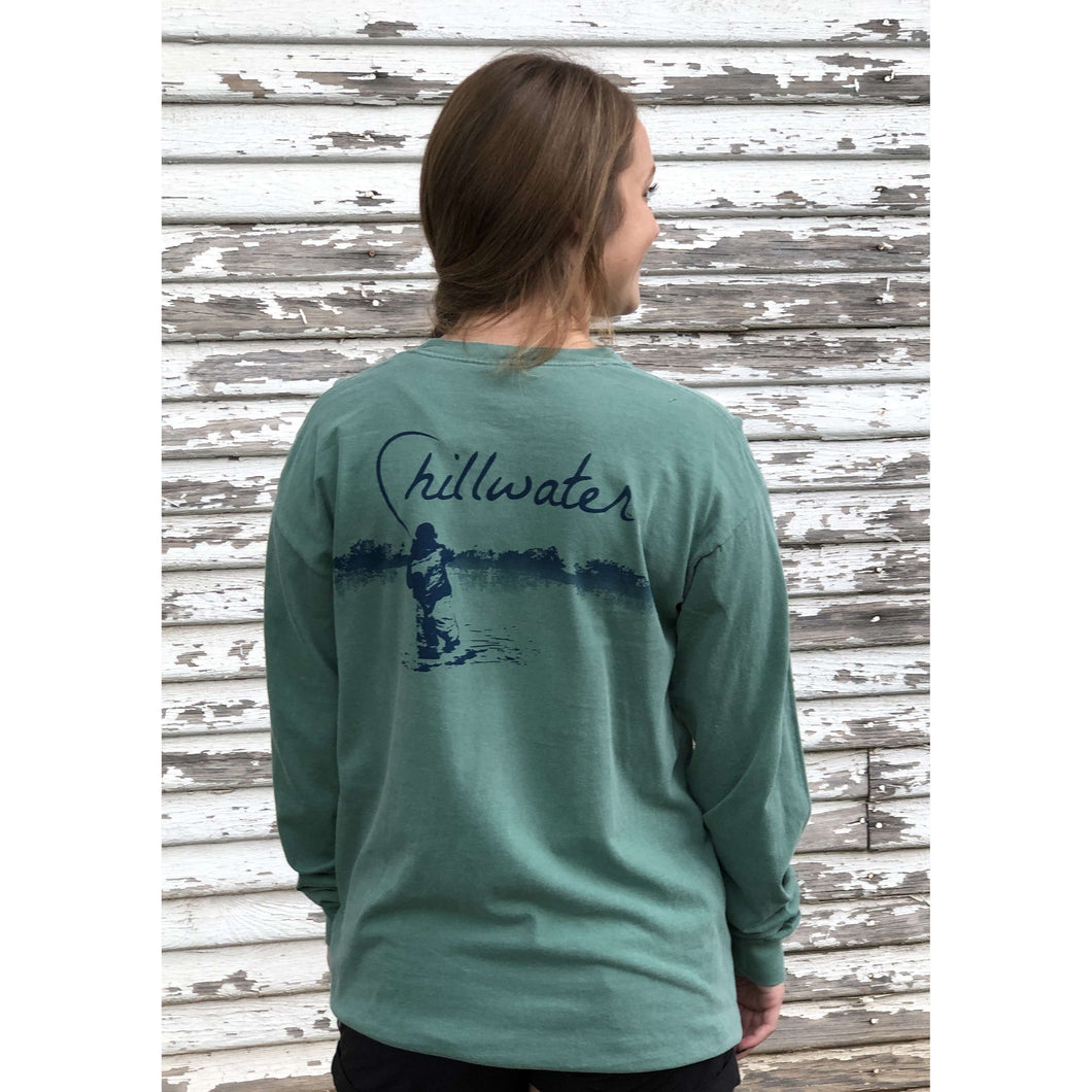 Young woman in green chillwater long sleeve with angler fishing design on the back. Design features fly fisherman wading in a body of water.