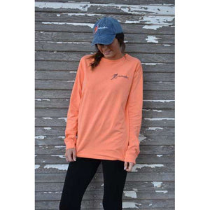 Young woman in orange long sleeve chillwater shirt with angler fishing design on the front. Front design features a fly fishing hook on the left chest.
