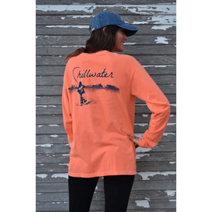 Young woman in orange long sleeve chillwater shirt with angler fishing design on the back. Design features fly fisherman wading in a body of water.