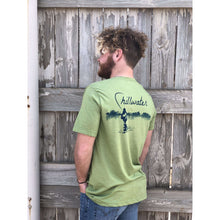 Man in green chillwater tshirt with angler design. Design features fly fisherman wading in a body of water.
