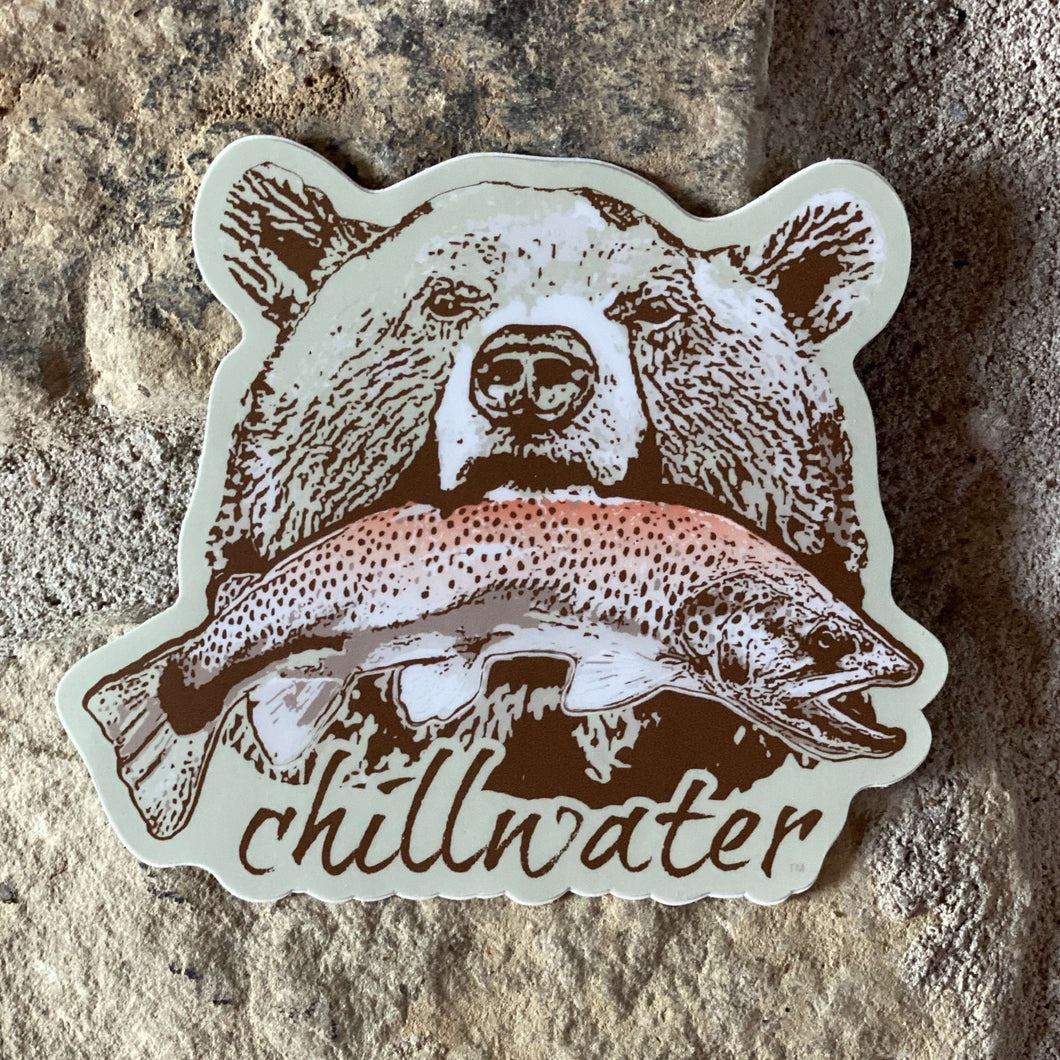 Grizzly Bear Sticker with pink salmon in light green background by Chillwater Apparel.