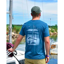 Short sleeve tshirt in blue with chillwater beach bound design on the back. Design is a white sailboat resting on a beach with ocean scene in background.