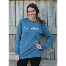 Woman in long sleeve blue t-shirt featuring the chillwater logo on the front and beach bound design on the back.