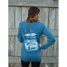 Long sleeve t-shirt with chillwater's beach bound design on the back. Design includes a sailboat resting on a white beach with an ocean background.