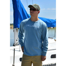 Man in long sleeve blue t-shirt featuring the chillwater logo on the front and beach bound design on the back.