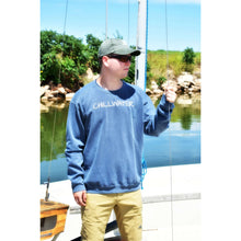 Man in faded navy sweatshirt with chillwater logo on the front and beach bound design on the back.