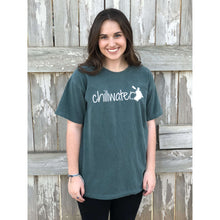 Young female wearing a trees of evergreen short sleeve tee with the Kayak design by Chillwater. The back resembles a kayaker floating down a river covered by trees.