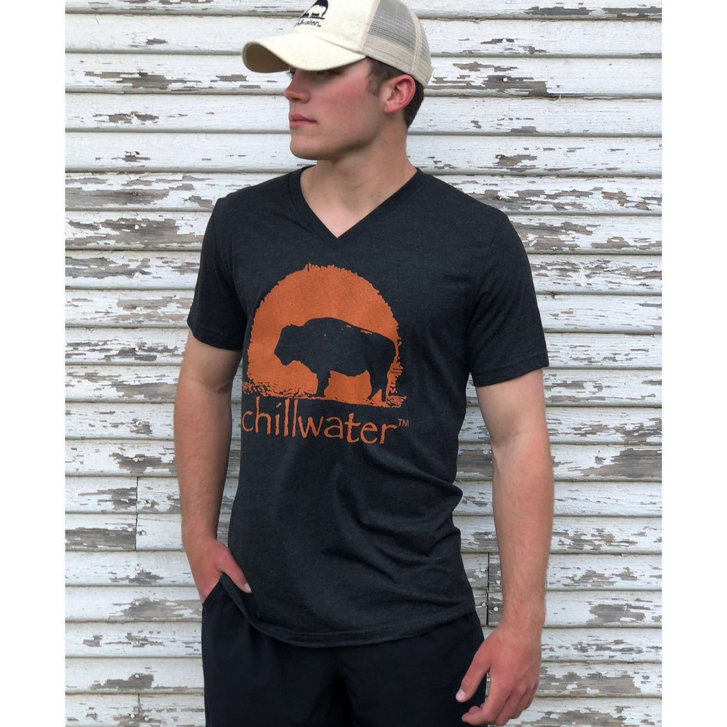 Young male wearing Chillwater's dark gray and orange Buffalo design V-neck short sleeve tee.