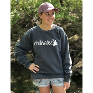 Young female wearing a sailor’s navy sweatshirt with the Kayak design by Chillwater. The back resembles a kayaker floating down a river covered by trees.