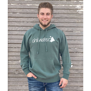 Young male wearing a trees of evergreen sweatshirt hoodie with the Kayak design by Chillwater. The back resembles a kayaker floating down a river covered by trees.