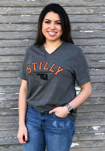 Short sleeve v-neck t-shirt with orange stilly logo and small black oklahoma with orange star over stillwater location.