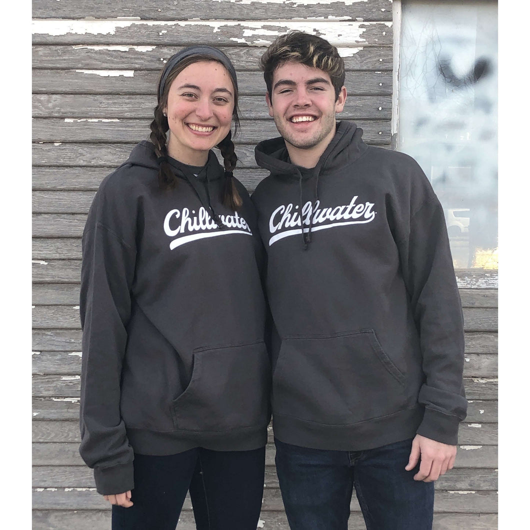 Two people wearing grey chillwater hoodies with vintage chill design. Design is in a white script font on the front center.