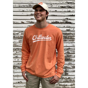 Man in long sleeve orange chillwater vintage chill tee. Design is in a white script font on the front center.